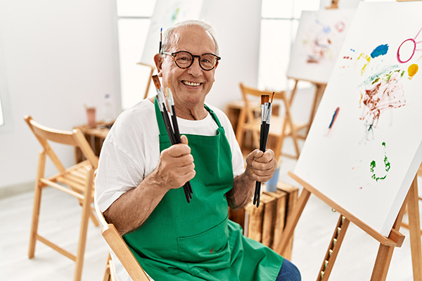 senior man painting a canvas