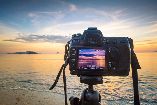 Camera filming the ocean sunset
