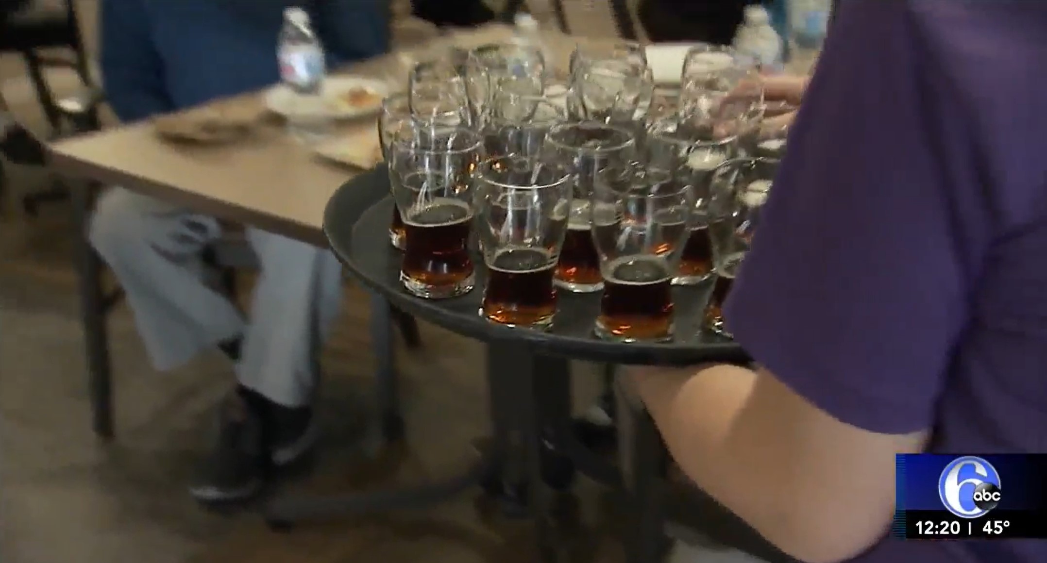 server carrying tray of beers
