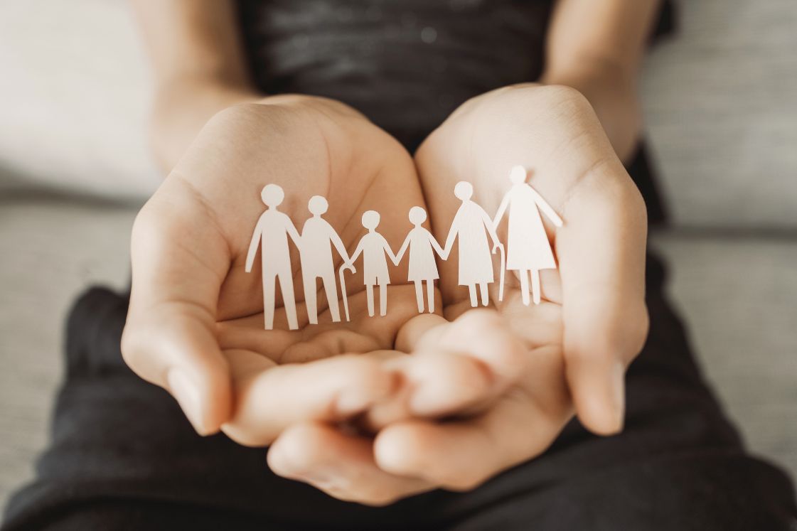 Hands Holding Cutout Paper People
