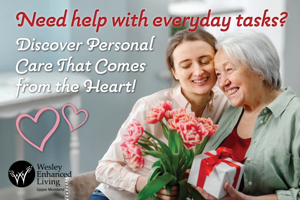Valentines Day Event for Personal Care at WEL Upper Moreland, senior woman and daughter smiling with flowers and a gift