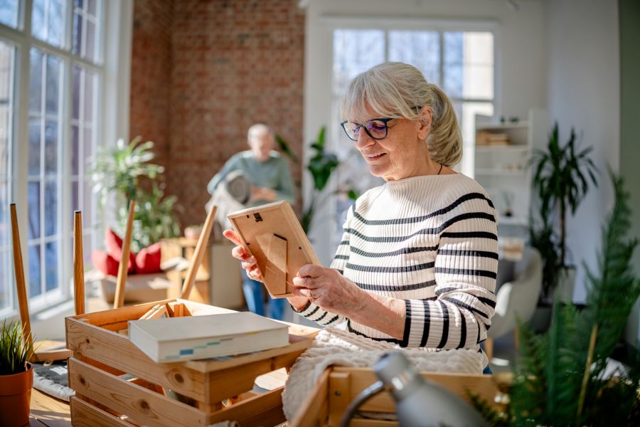 Senior woman downsizing the Scandinavian way, getting rid of clutter